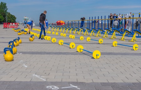 DNEPR, UKRAINE - MAY 21, 2016:Young people working on the Dnepr river embankment preparing for workout festival at May 21, 2016 in Dnepr, Ukraineのeditorial素材