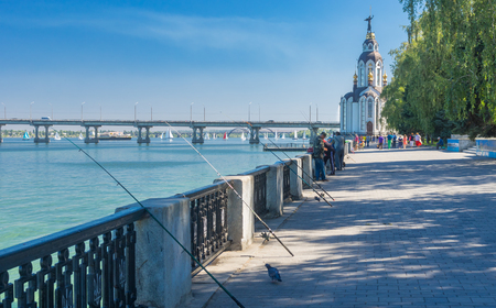 DNEPR, UKRAINE - SEPTEMBER 10, 2016:Dnepr river embankment with fishermen and their rods during City Day local activityのeditorial素材