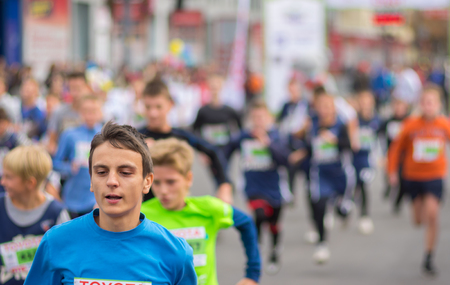 DNEPR, UKRAINE - SEPTEMBER 25, 2016:Young participants hurrying to finish line during kids section...