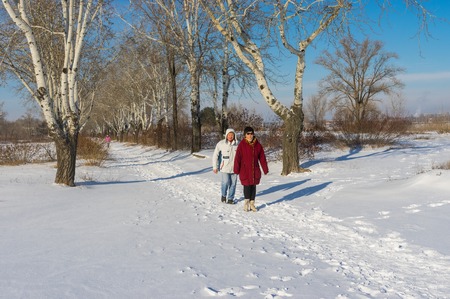 DNEPR, UKRAINE - JANUARY 08 2017: People walking in winter park at sunny weekend in Dnepr city, Ukraineのeditorial素材