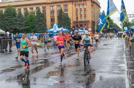 DNIPRO, UKRAINE - MAY 20, 2018: Group of participants running on the central street of Dnipro city.のeditorial素材