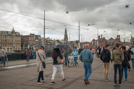 AMSTERDAM, NETHERLANDS - August 09, 2016: Pedestrians walking on a street near Amsterdam Central at August 09, 2016のeditorial素材