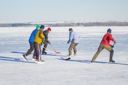 Dnipro, Ukraine - January 22, 2017: Group of different ages people playing hockey on a frozen river Dnepr in Ukraineのeditorial素材