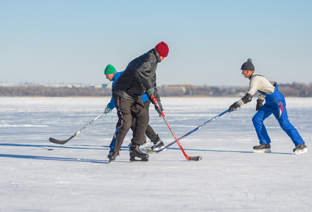 Dnipro, Ukraine - January 22, 2017: Group of mature men playing hockey on a river Dnipro in Ukraineのeditorial素材