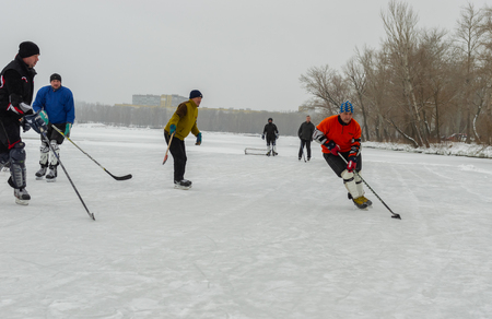 Dnipro, Ukraine - January 28, 2018:Group of ordinary people playing hokey on a frozen river Dnipro in Ukraineのeditorial素材