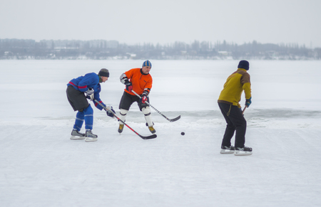Dnipro, Ukraine - January 28, 2018: Group of different aged people playing hokey on an iced river Dnipro in Ukraineのeditorial素材