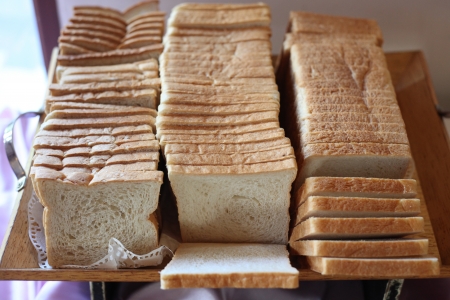 A loaf of sliced brown and white bread 