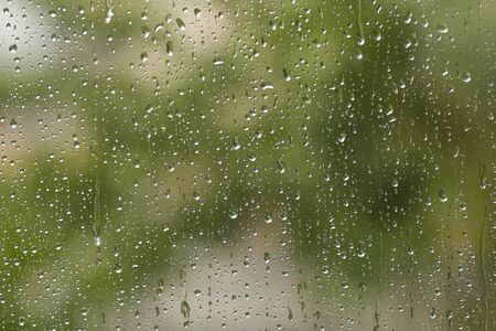 Glass with natural water drops. Rainy day. Autumn concept.