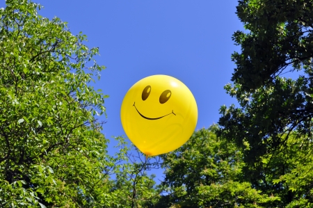 smiling balloon on the trees backgroundの写真素材