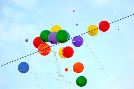 festival is over   multicolored balloons catch on electric cable