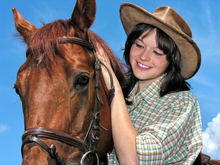 portrait of young cowgirl and horse outdoors