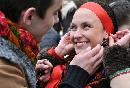 outdoor portrait of two young ukrainian people in traditional ukrainian clothes in the meetingの写真素材