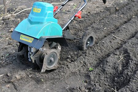 Cherkasy, Ukraine - May 10, 2018: Hand electric tractor plow plough for agricultural work at the vegetable gardenのeditorial素材
