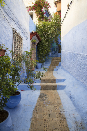 One narrow alley of the blue medina of Chefchaouenの写真素材