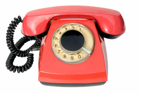 An old red telephone set isolated on whiteの写真素材