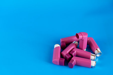 Asthma inhalers on a blue background with a copy spaceの写真素材
