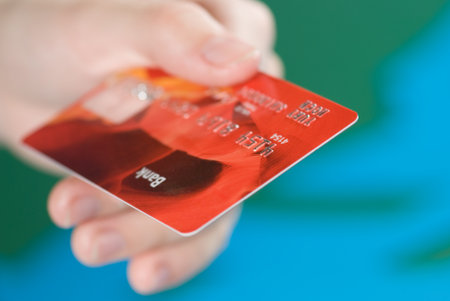 A hand with a credit card. Shallow DOFの写真素材