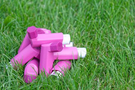 Asthma inhalers on a green grass meadow with a copy spaceの写真素材