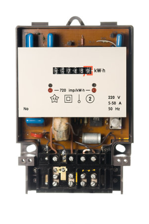 An old analogue active energy meter on white
