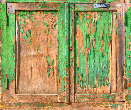 Old weathered dirty wooden door with peeling paintの写真素材