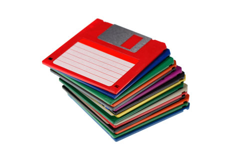A stack of vintage computer colored floppy disks Isolated on white. Old technologies. Selective focus. Low DOFの写真素材