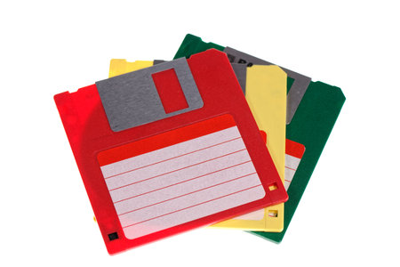A stack of vintage computer colored floppy disks Isolated on white. Old technologies. Selective...