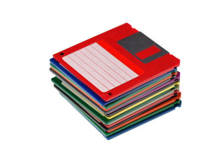 A stack of vintage computer colored floppy disks Isolated on white. Old technologies. Selective focusの写真素材