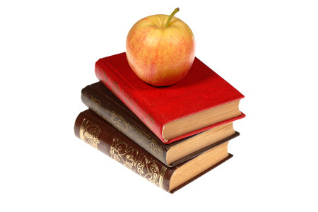 A stack of old books with apple isolated on white background. Selective focusの写真素材
