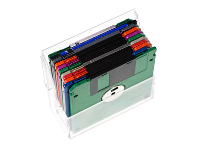 A pack of vintage computer colored floppy disks Isolated on white. Old technologies. Selective focusの写真素材