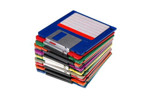 A stack of vintage computer colored floppy disks Isolated on white. Old technologies. Selective focus. Low DOFの写真素材