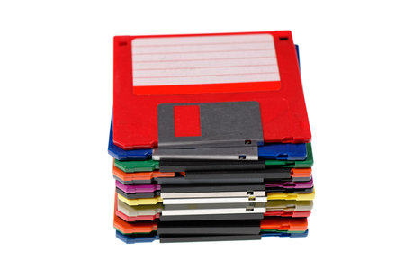A stack of vintage computer colored floppy disks Isolated on white. Old technologies. Selective focusの写真素材