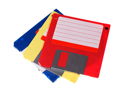 A stack of vintage computer colored floppy disks Isolated on white. Old technologies. Selective focusの写真素材
