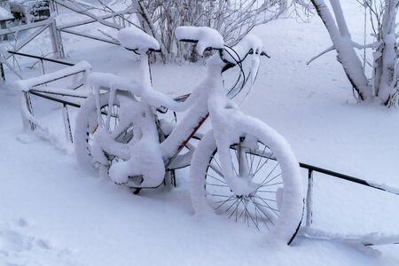 After a very heavy snowfall in the courtyard of Kronstadt remained snow-covered bike.の写真素材