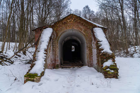 Russia. Kronstadt. March 14, 2021. Abandoned well-camouflaged concrete and wooden storage facilities for artillery and mine weapons on the site of a former military arsenal.のeditorial素材