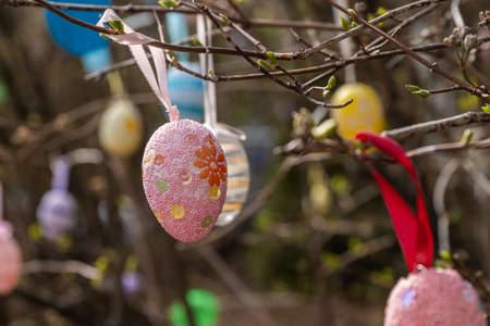 Russia. May 1, 2021. Easter decorations and signs on trees near the Orthodox church in Kronstadt.のeditorial素材