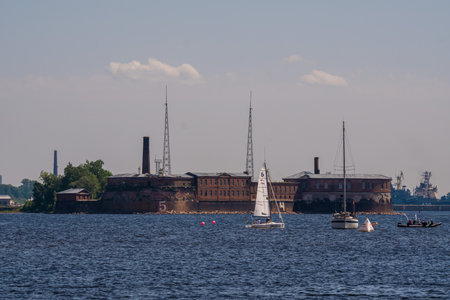 Russia June 6, 2021. Yachts and boats during the sailing regatta at the Kronstadt Sail Festival take place against the backdrop of the Emperor Peter I Fort, located near the fairway on the southern coast of Kronstadt.のeditorial素材