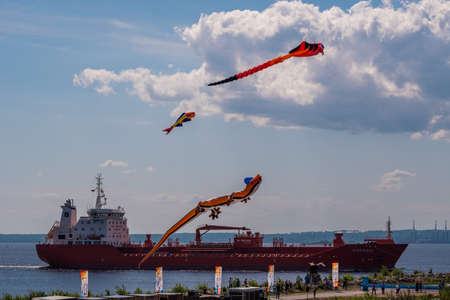 Russia. Kronstadt. June 6, 2021. Aerial flying figures in the form of various animals and creatures on the background of a passing ship over Fort Constantine during the Kronstadt Sailing Festival.のeditorial素材