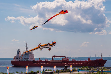 Russia. Kronstadt. June 6, 2021. Aerial flying figures in the form of various animals and creatures on the background of a passing ship over Fort Constantine during the Kronstadt Sailing Festival.のeditorial素材