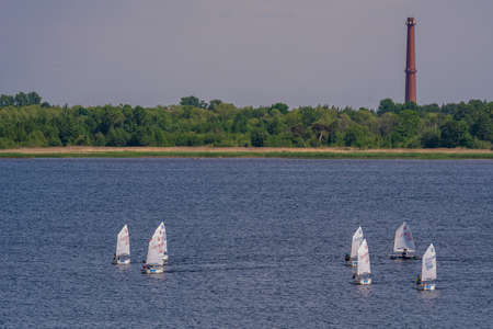 Russia. Kronstadt. June 6, 2021. Sailing competitions among Optimist class yachts near Fort Konstantin during the Kronstadt Sailing Festival.のeditorial素材