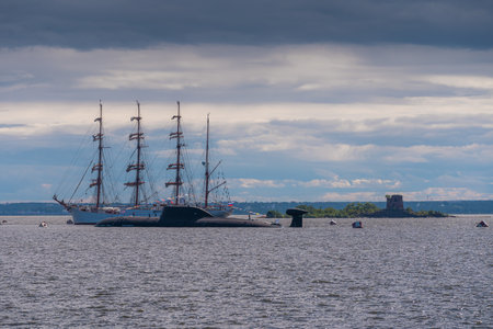 Russia. Kronstadt. July 31, 2022. A nuclear submarine and a sailing barque on the parade of the Navy.の写真素材
