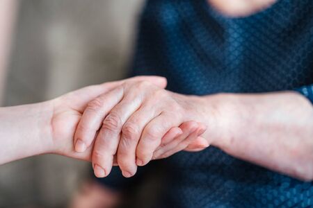 Caring for the older generation. Care for the elderly. Caring for elders about parents, grandparents. Hands in hands.の写真素材