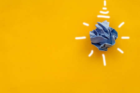 white paper light bulb, yellow background, Corporate social responsibility, responsible business, eco friendly, sustainable living, renewable energy concept, green energyの写真素材