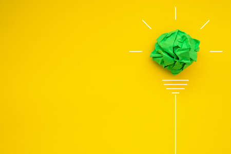 Creativity inspiration, ideas concepts with lightbulb from paper crumpled ball on color background.の写真素材