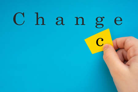 Male hand changing the word Change into Chancの写真素材