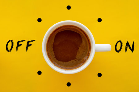 Coffee cup switch on off concept on yellow background. Morning wake up coffee break concept.