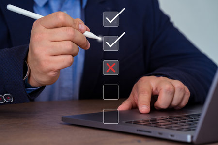 Close-up Of Businessman Working On Laptop With Check Box