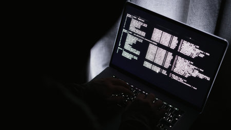 Monitor displays complex code, IT analyst examines logs carefully as alerts resonate faintly background, Dark environment with technician analyzing streaming code while alarms softly echo behindの写真素材