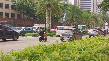 City streets experience continuous flow of moving vehicles daily and seamlessly, bustling urban...
