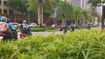 Couriers hustle amid city traffic, delivery personnel maneuver through bustling streets during peak hours, scooter riders and couriers swiftly traverse crowded roads amidstのeditorial素材