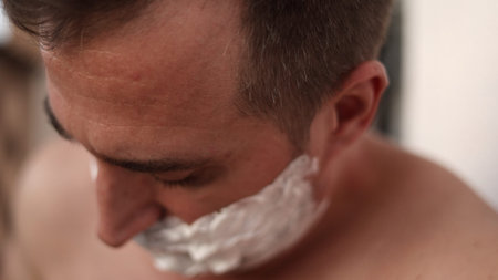 Grooming postexercise, Man trimming beard after workout, Close view of man shaving post exercise...